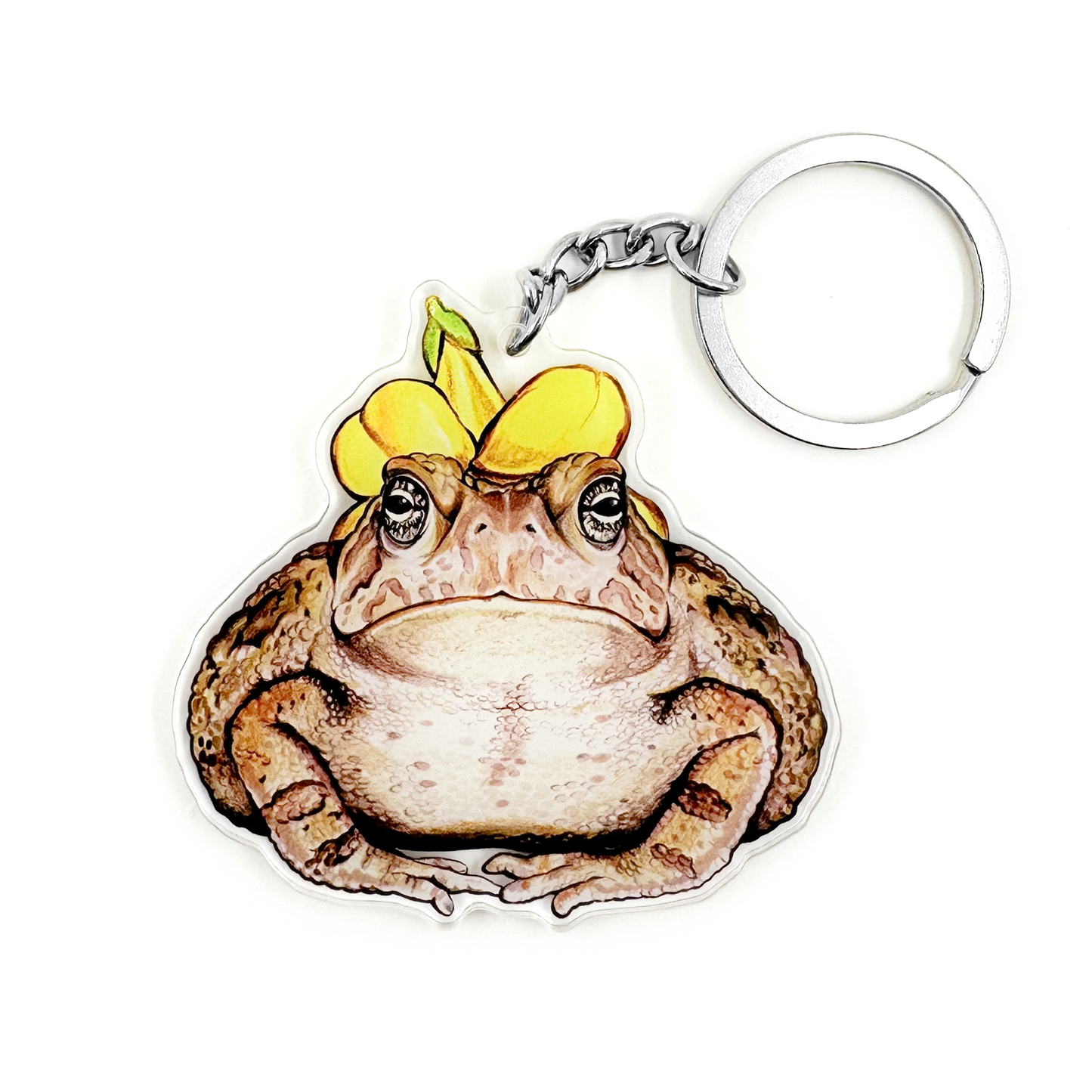 A keychain featuring an illustration of a Fowler's toad wearing a flower hat