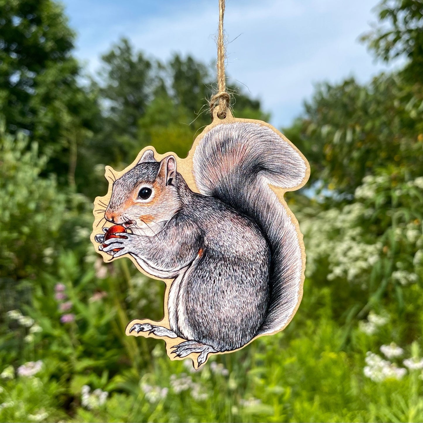 A wooden ornament strung with twine of an eastern gray squirrel.