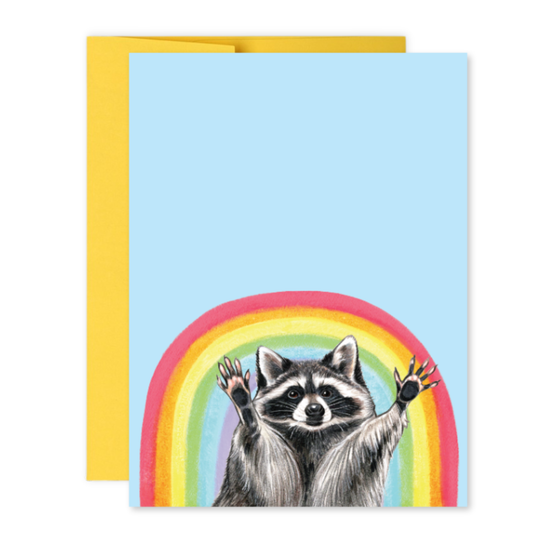 Greeting card with a raccoon and a rainbow on a light blue background