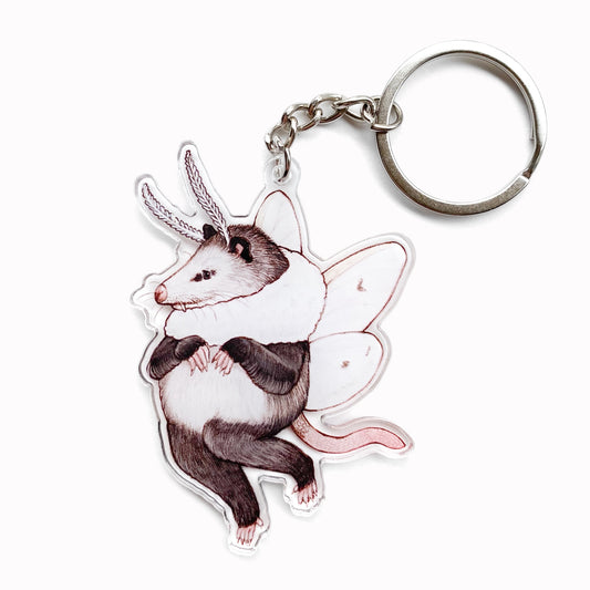 A keychain of an opossum with agreeable tiger moth wings