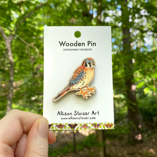 A wooden pin of an American kestrel