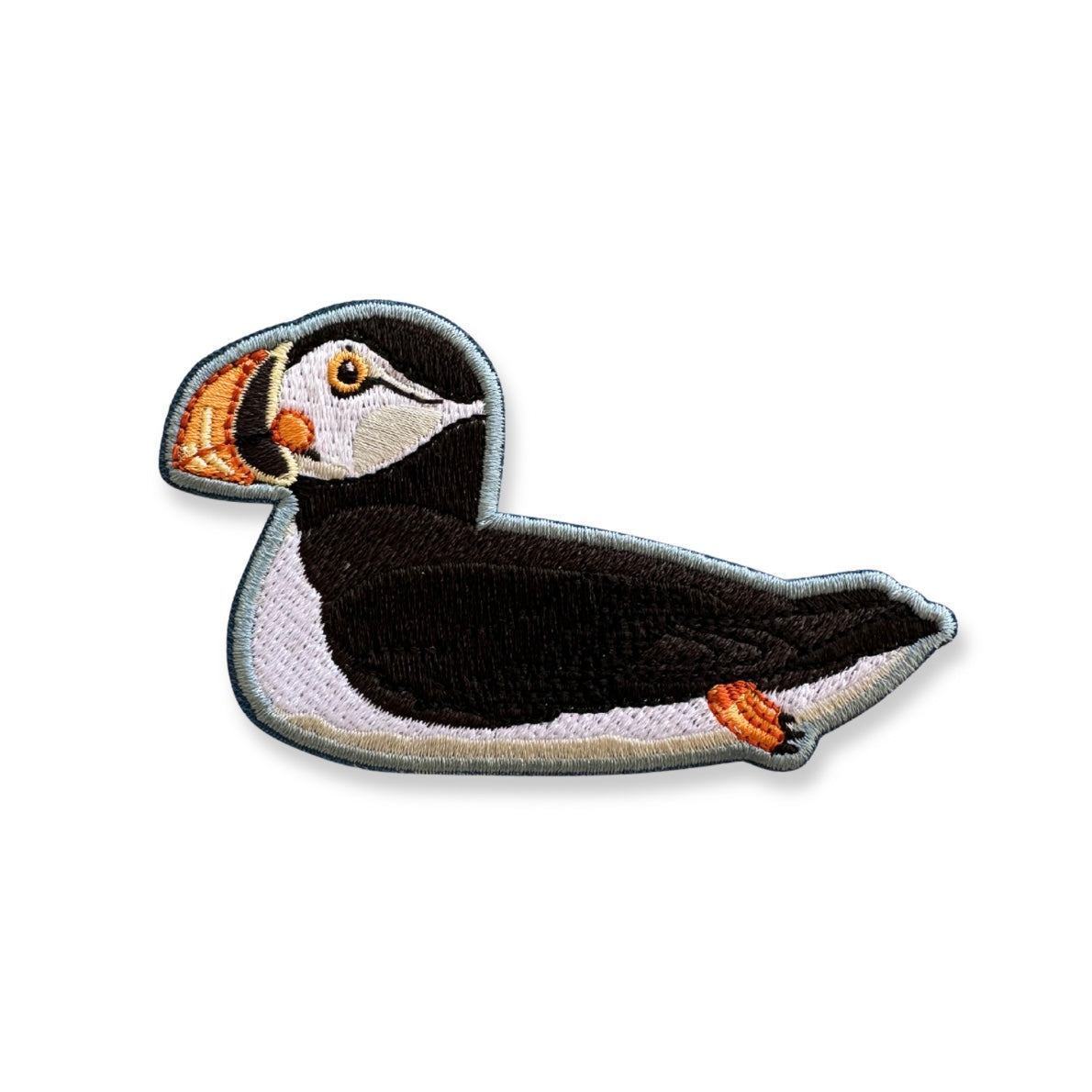 Embroidered patch of an Atlantic puffin on a white background