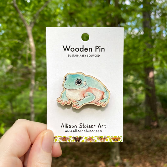 A wooden pin of an Australian green tree frog
