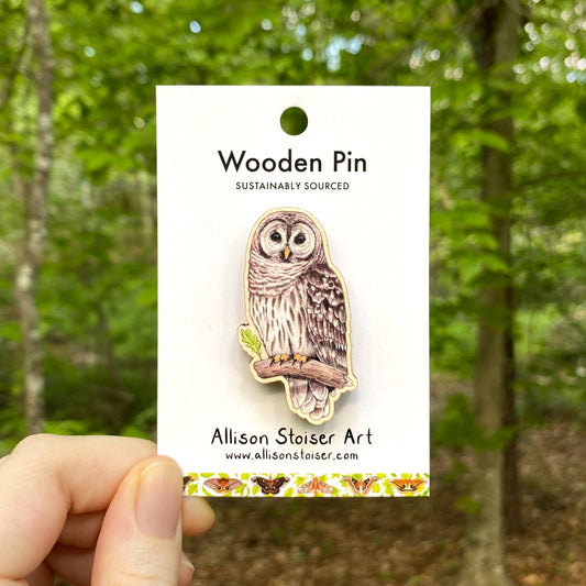 A wooden pin of a barred owl