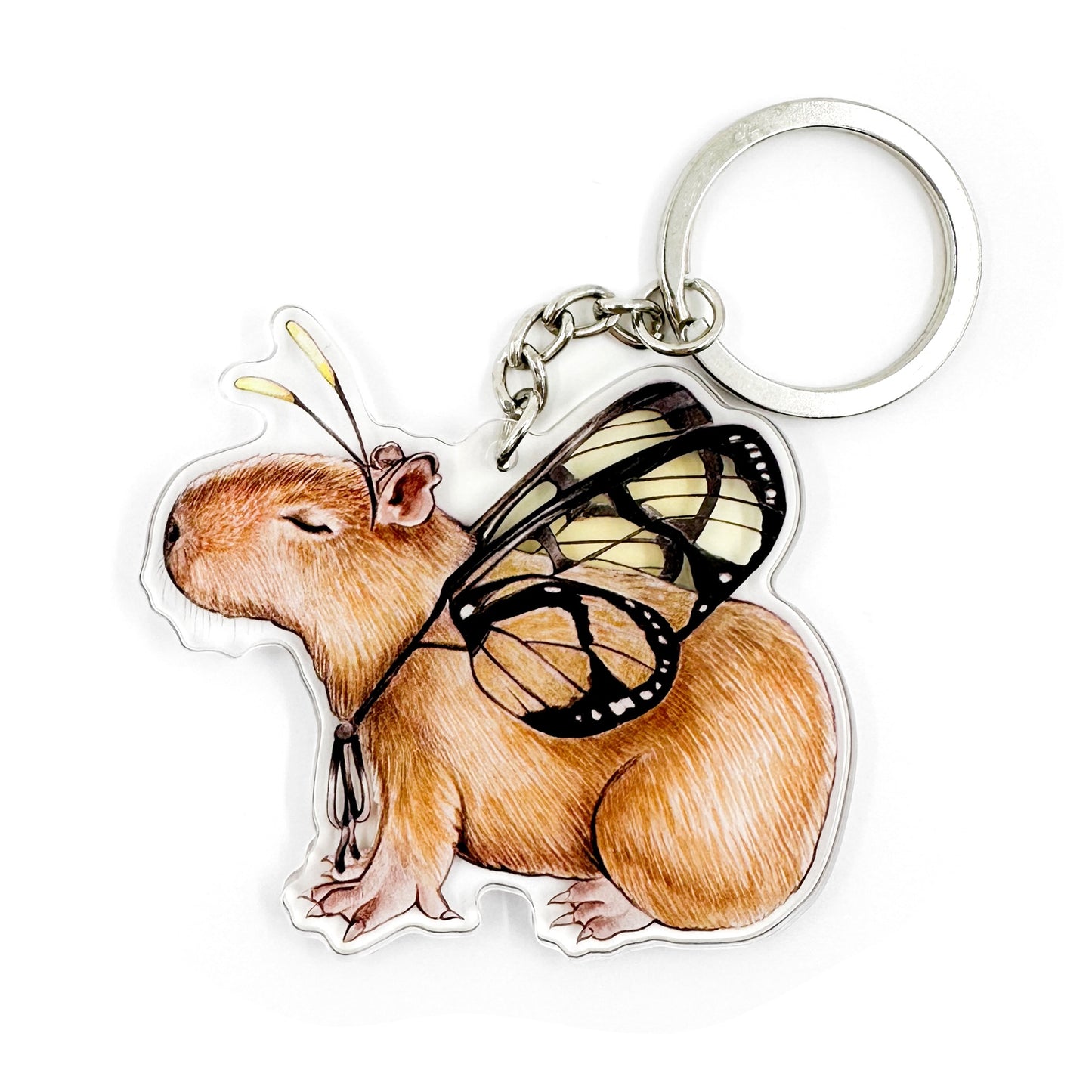 A keychain featuring an illustration of a capybara with butterfly wings