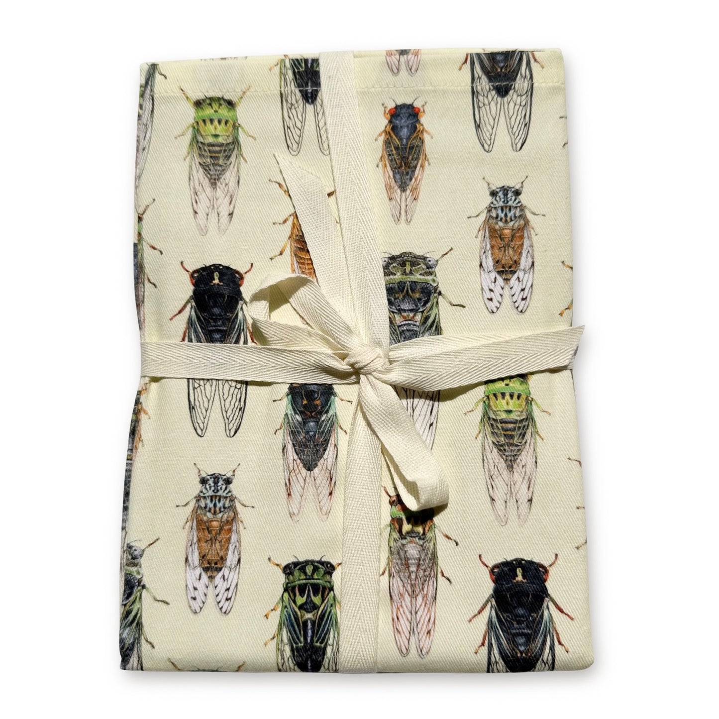 A folded cream-colored tea towel featuring a repeating pattern of detailed cicada illustrations, tied with a cream ribbon bow on a white background.
