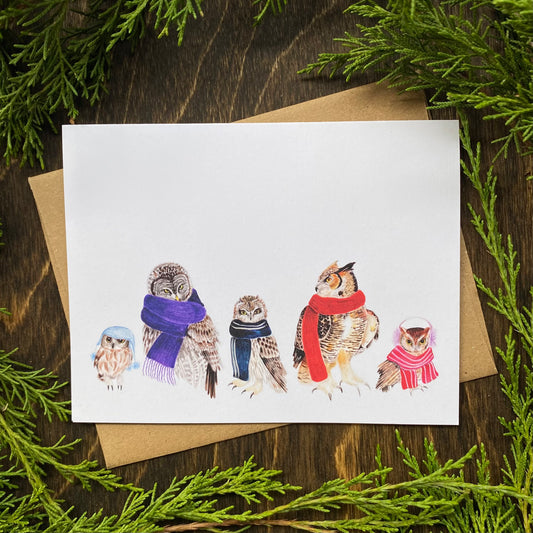 A card featuring a series of owls wearing scarves