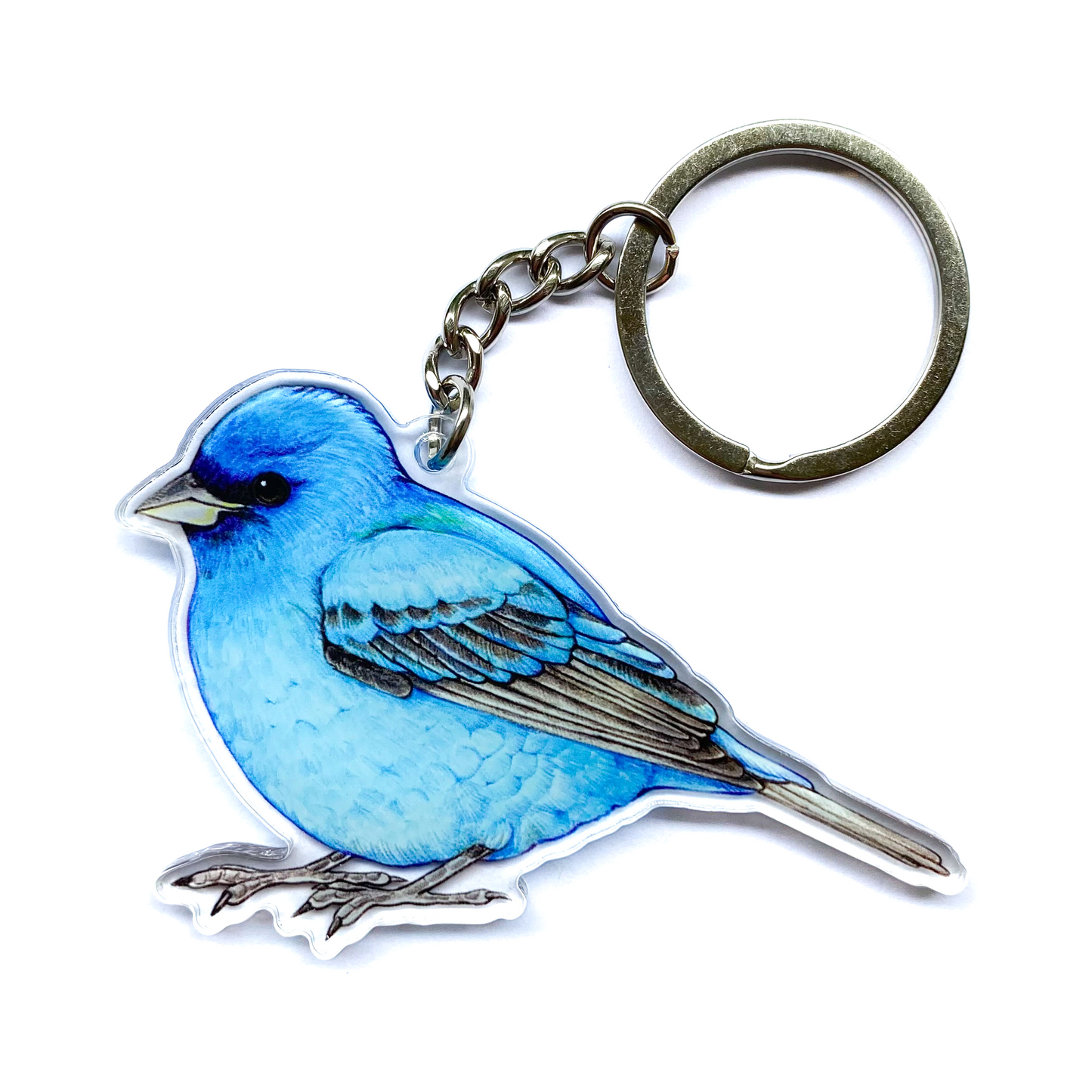 Indigo bunting keychain on a white background