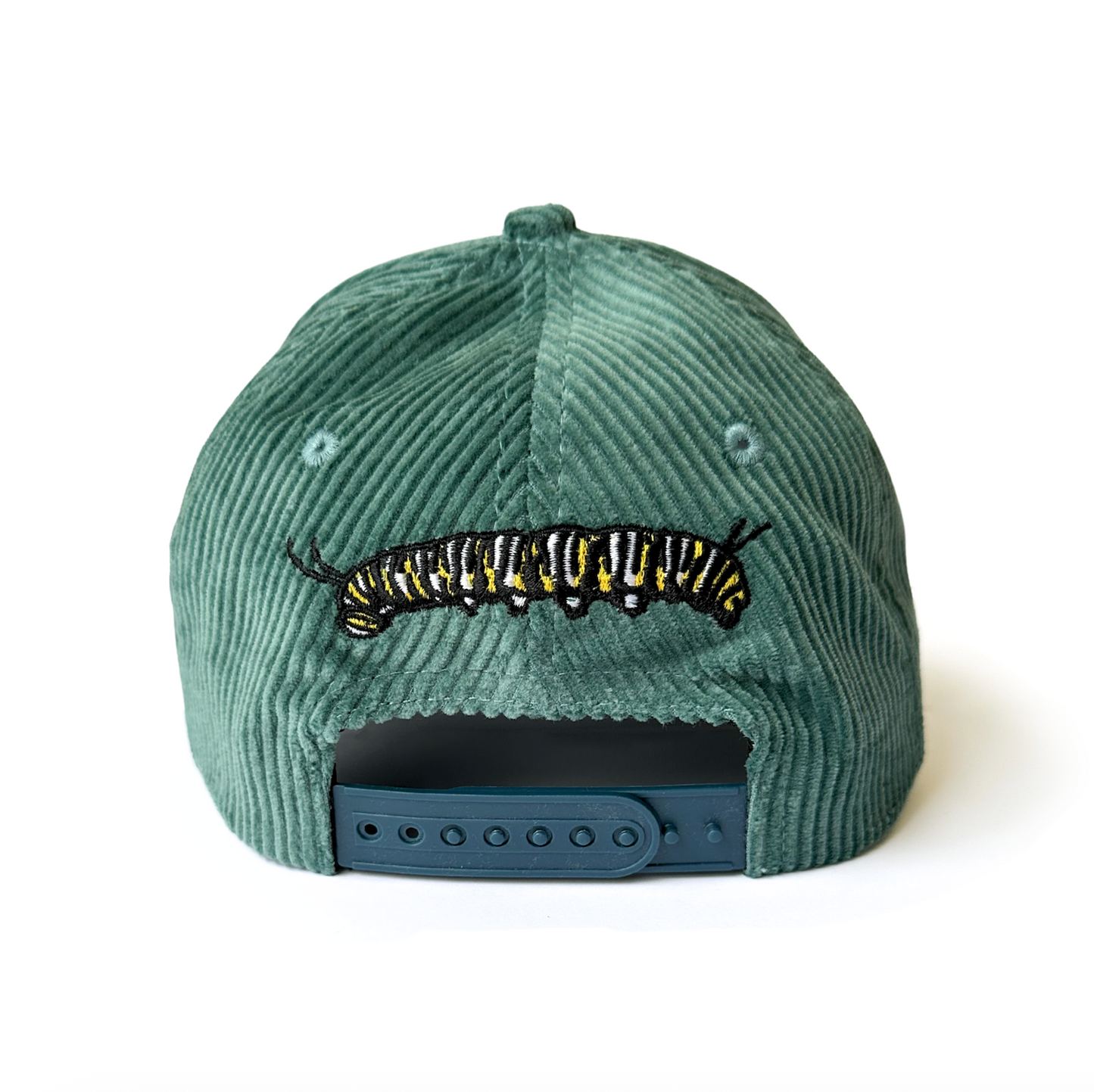 Green corduroy cap with a monarch caterpillar design on a white background