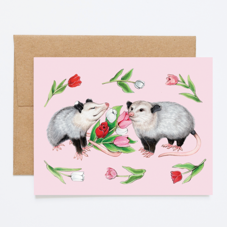 A card with opossums and tulips on a pink background