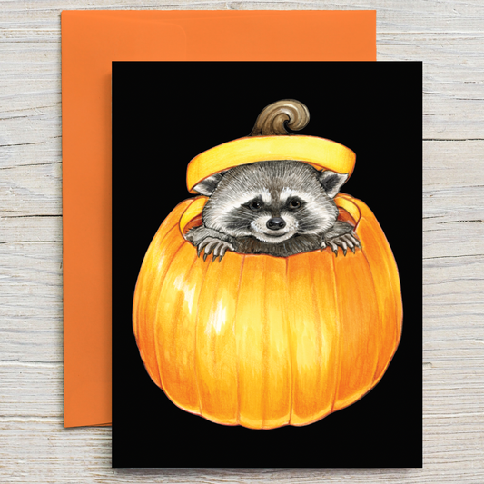 This card features an illustration of a mischievous raccoon peeking out from a pumpkin.  