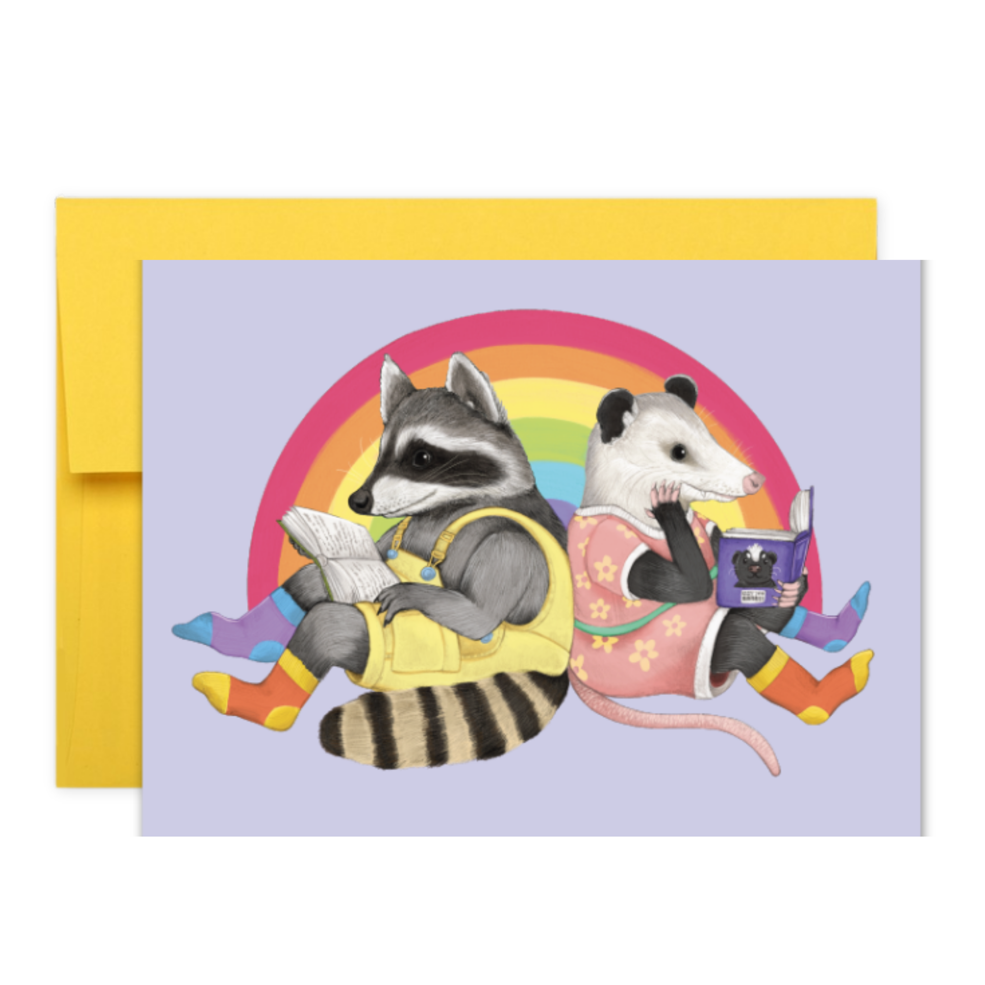 Card with a raccoon and opossum reading books against a rainbow background, with a yellow envelope.