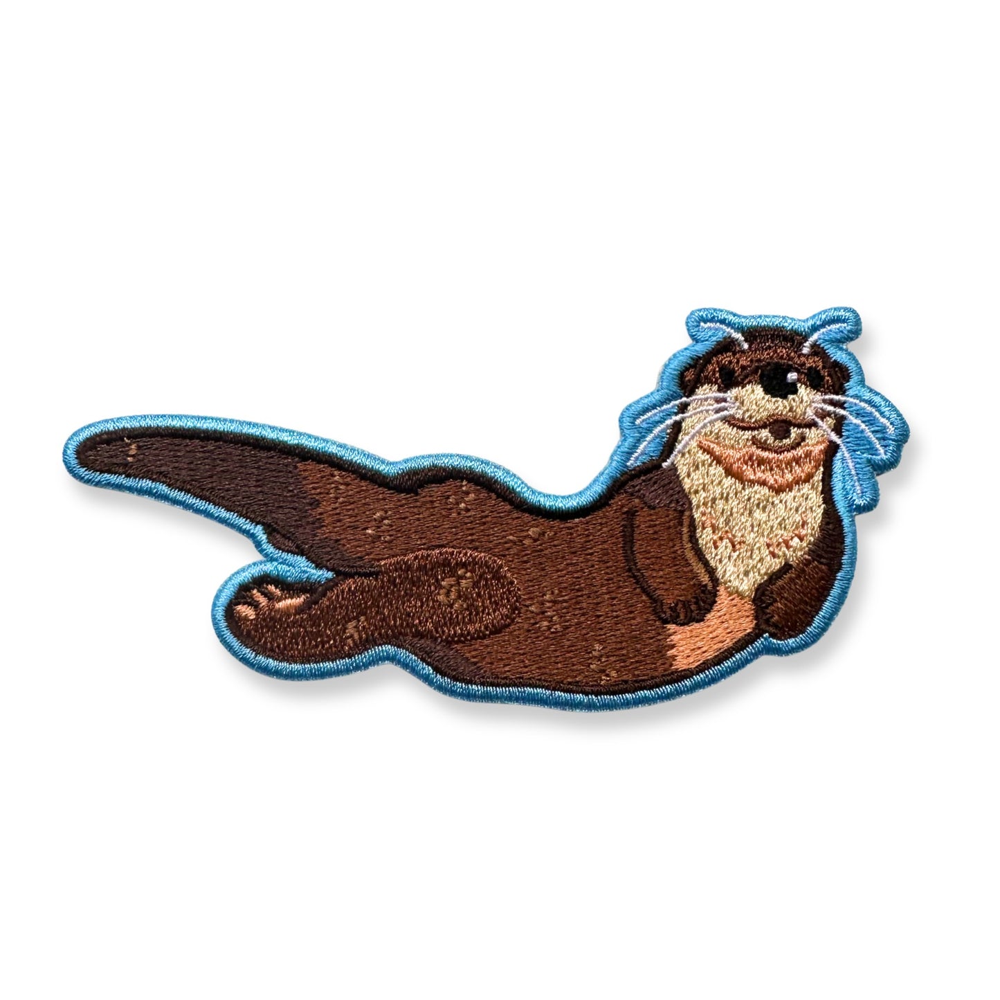 An embroidered patch of a river otter with a light blue stitched outline, shown on a plain white background.