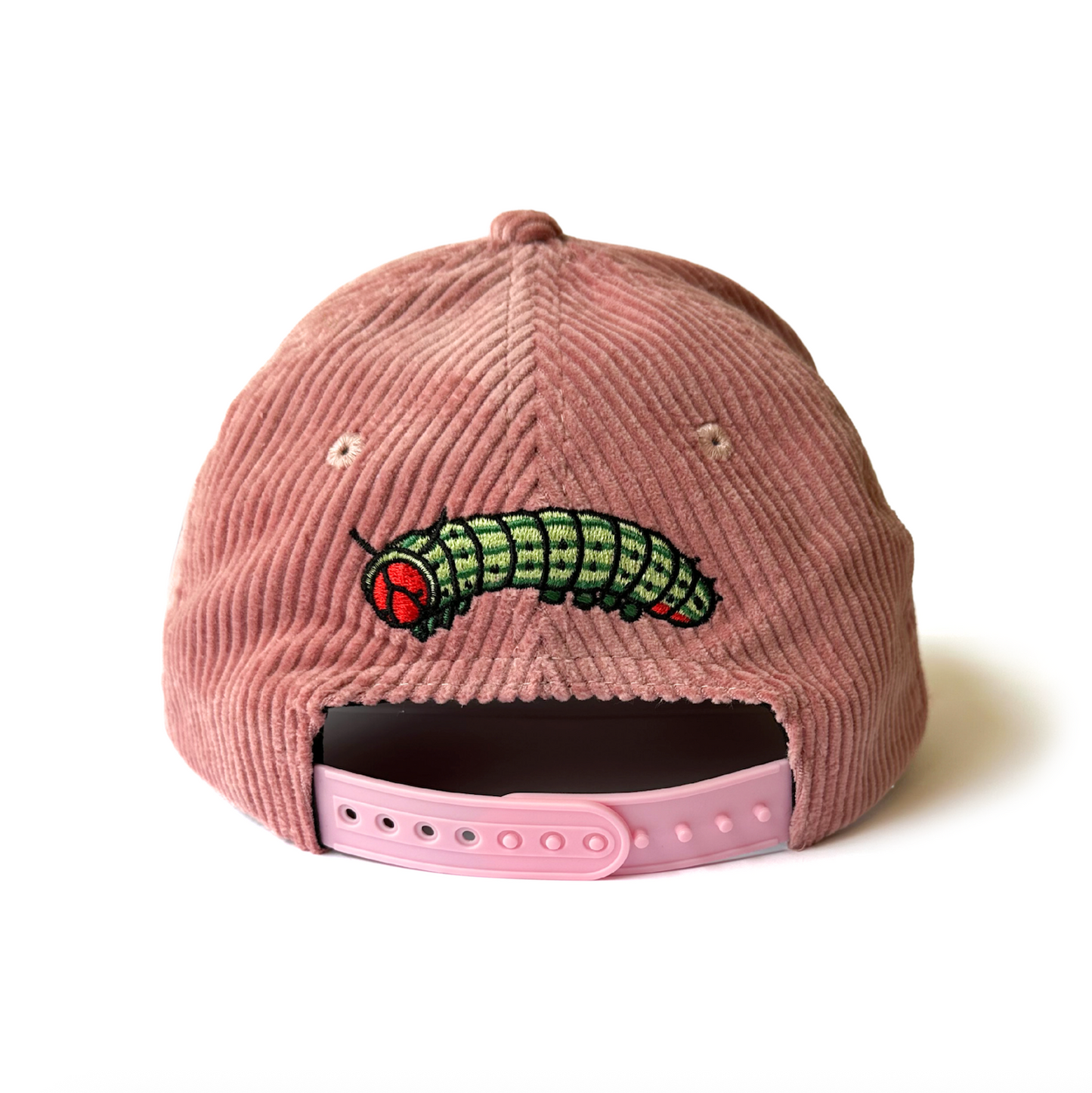 Pink corduroy cap with a caterpillar embroidered on the back, on a white background