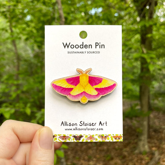 A wooden pin of a rosy maple moth