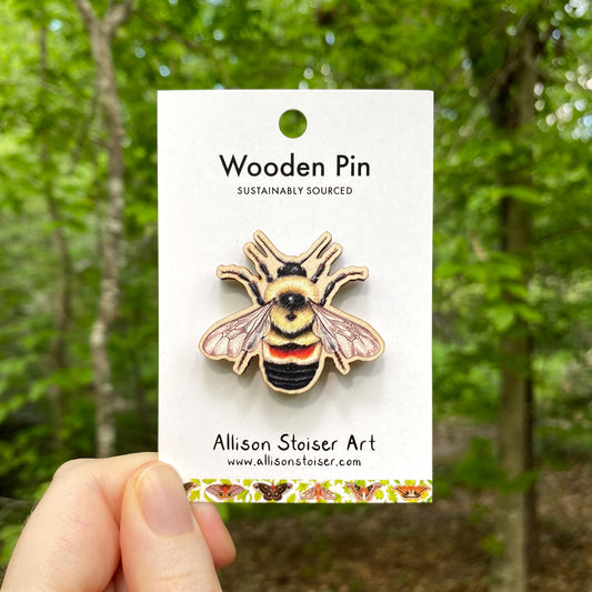 A wooden pin of a rusty-patched bumblebee