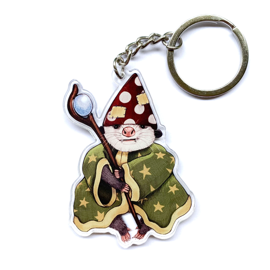 Keychain with an opossum in a wizard costume holding a staff on a white background