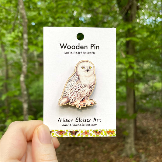 A wooden pin of a snowy owl