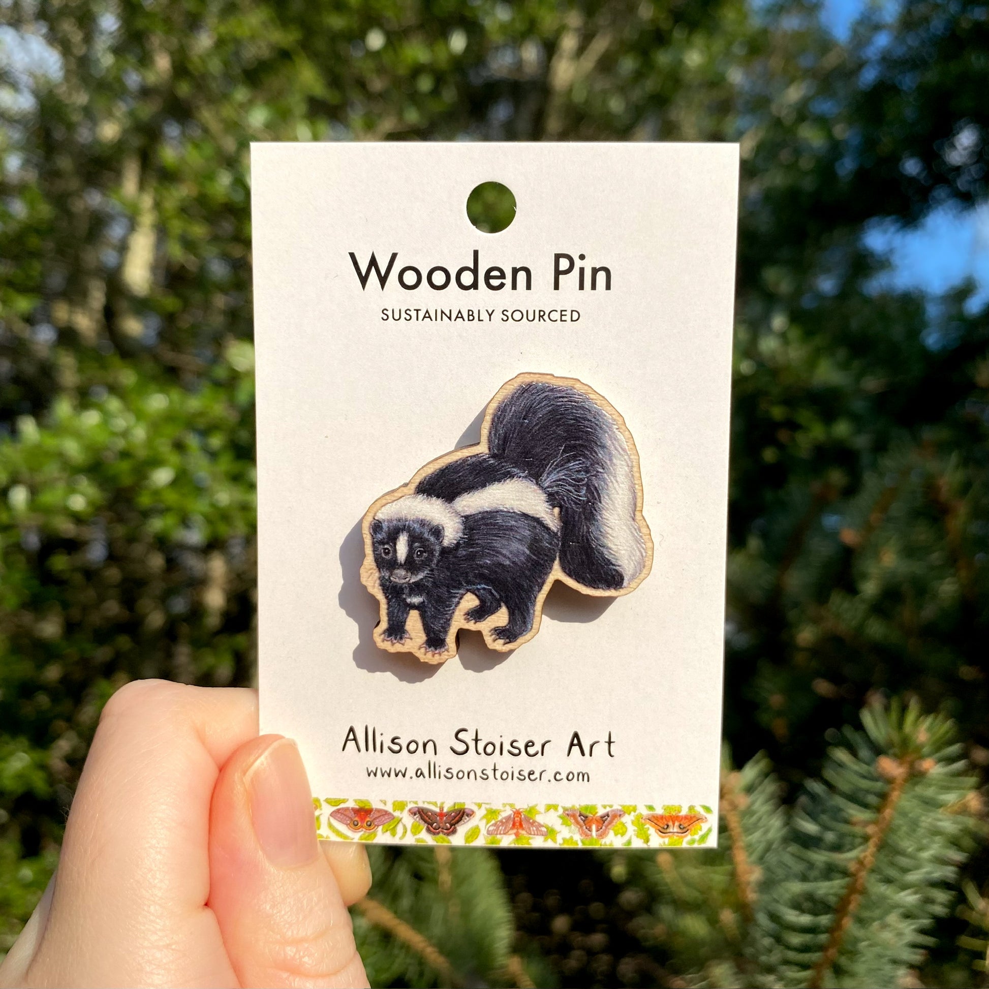 A wooden pin of a striped skunk