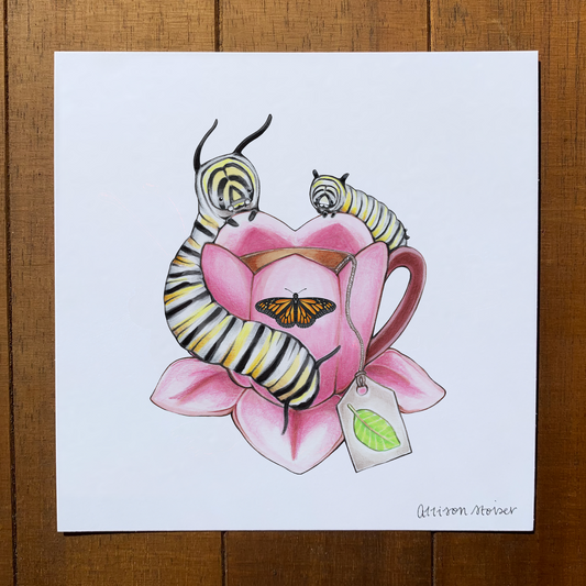 Illustration of monarch caterpillars on a pink flower-shaped teacup on a wooden surface.