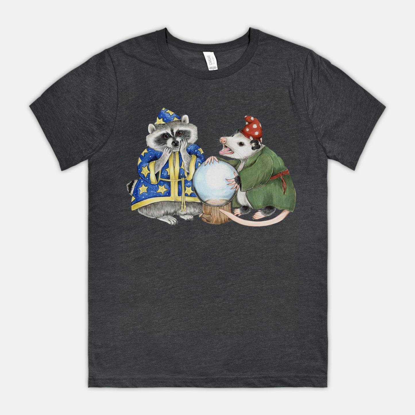A dark orange-colored shirt featuring a cowboy opossum and text reading “Y’all Means All”