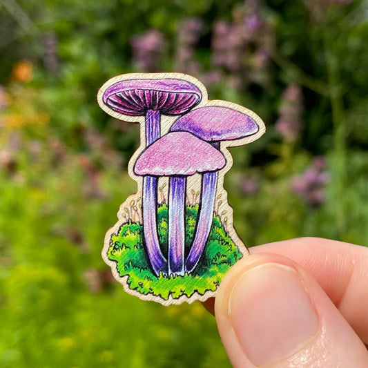A sustainably sourced pin featuring an illustration of an amethyst deceiver mushroom