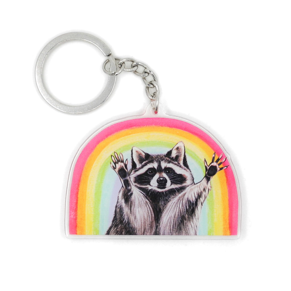 A keychain featuring a raccoon with raised hands posed in front of a rainbow