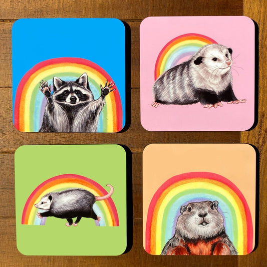A coaster set featuring creatures posed in front of rainbows