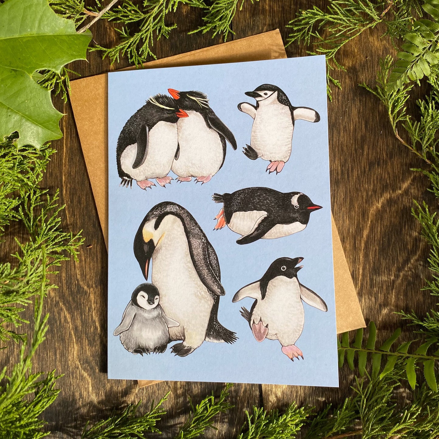 A folding card featuring a series of penguin illustrations