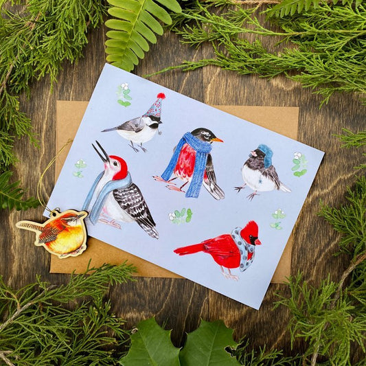 A folding card featuring winter birds wearing scarves