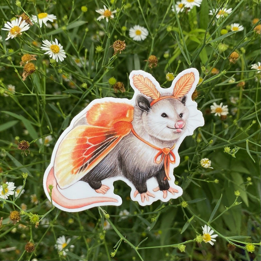 A weatherproof vinyl sticker featuring an illustration of an opossum dressed as a flannel moth