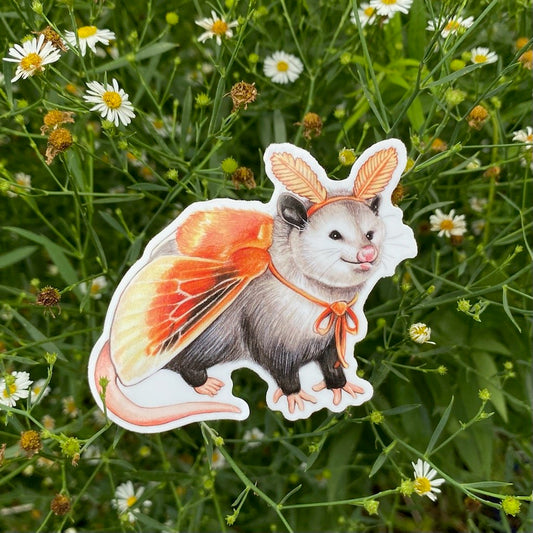 A weatherproof vinyl sticker featuring an illustration of an opossum dressed as a flannel moth