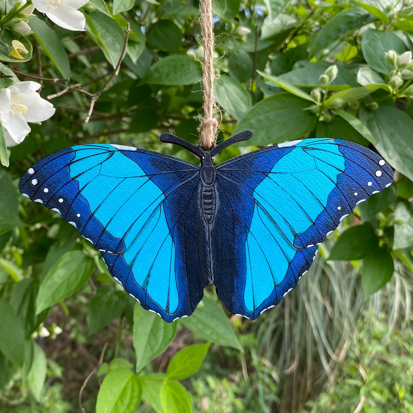 A hand-painted ornament of a Deidami morpho butterfly