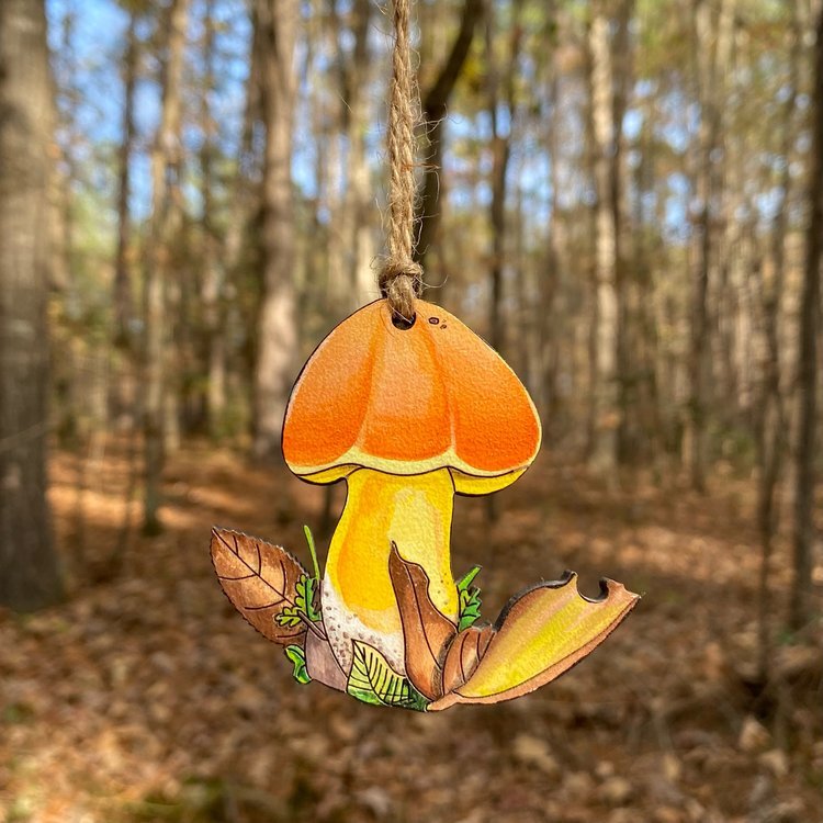 A hand-painted ornament of an orange bolete mushroom