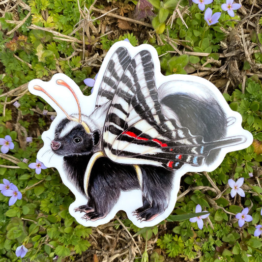 A hand holding a sticker featuring an illustration of a skunk dressed as a zebra swallowtail