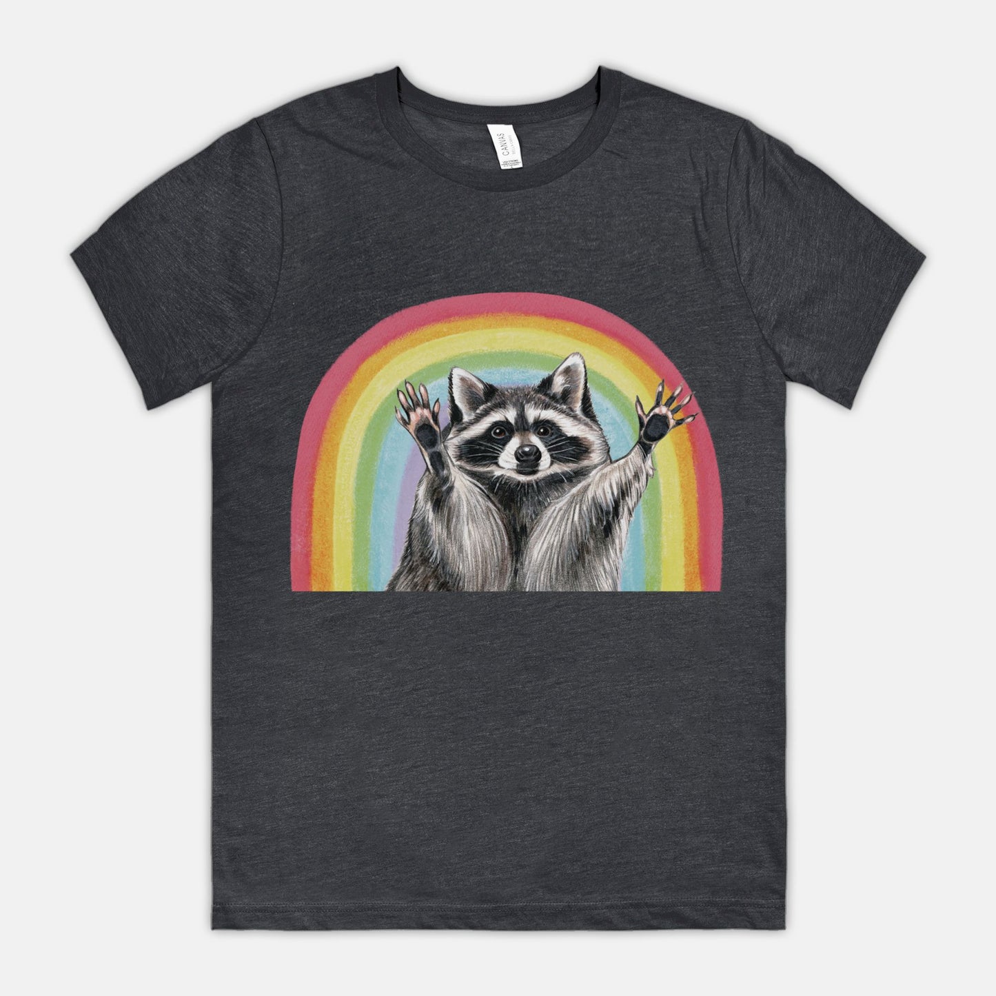 A dark gray t-shirt featuring an illustration of a raccoon with raised hands in front of a rainbow.