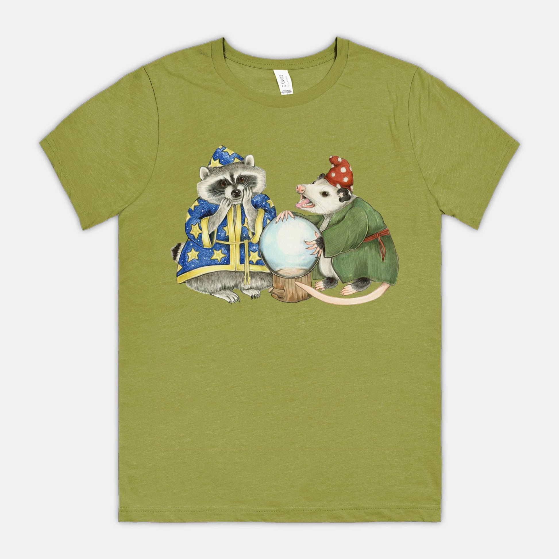 A green t-shirt featuring an illustration of a raccoon wizard and opossum fortune teller