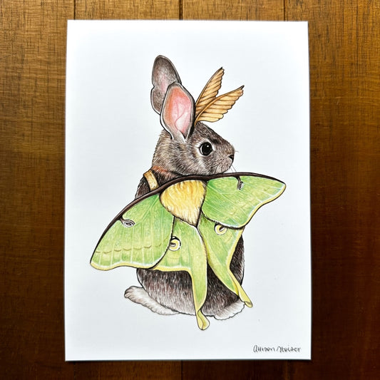 A 5" by 7" print of an eastern cottontail rabbit dressed up in luna moth wings.