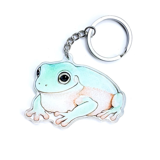 An Australian green tree frog keychain on a white background.