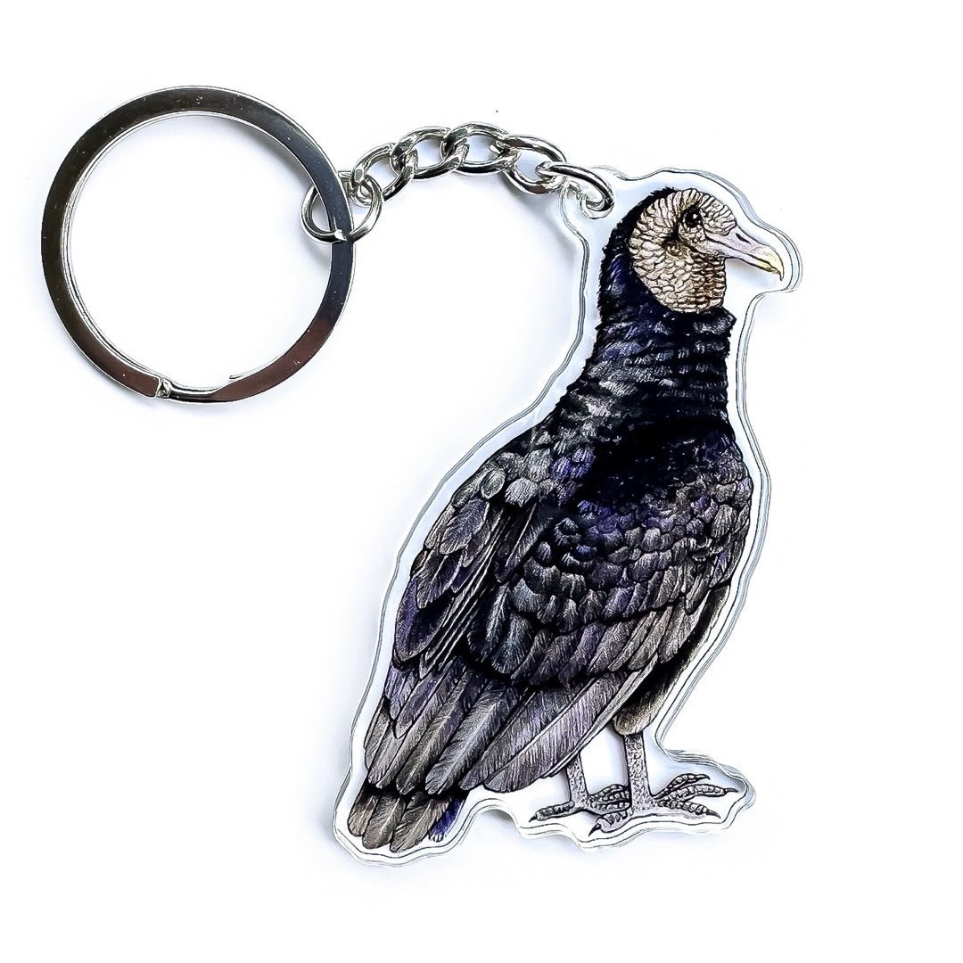 A black vulture keychain on a white background.