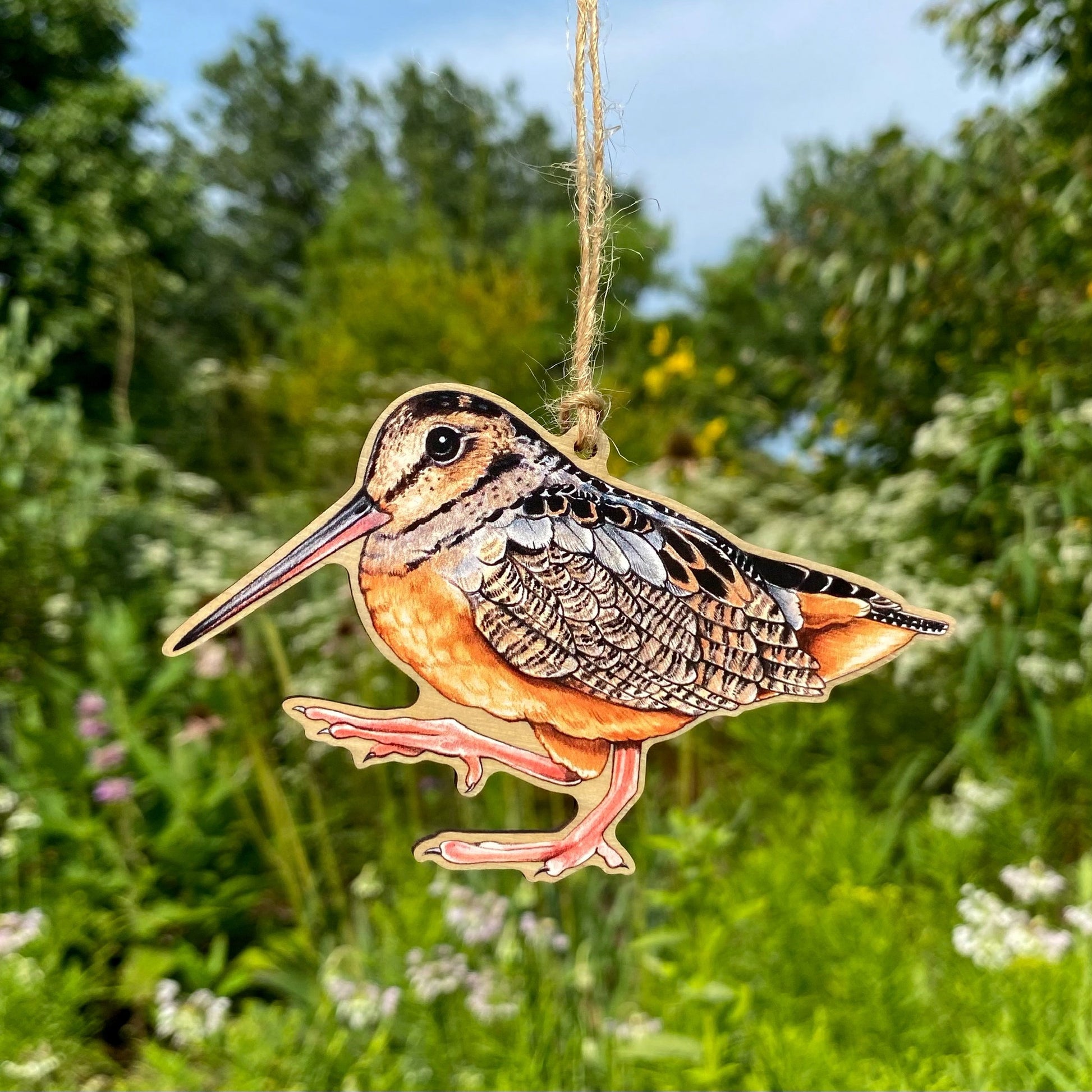 A wooden ornament strung with twine of an American woodcock, or timberdoodle.