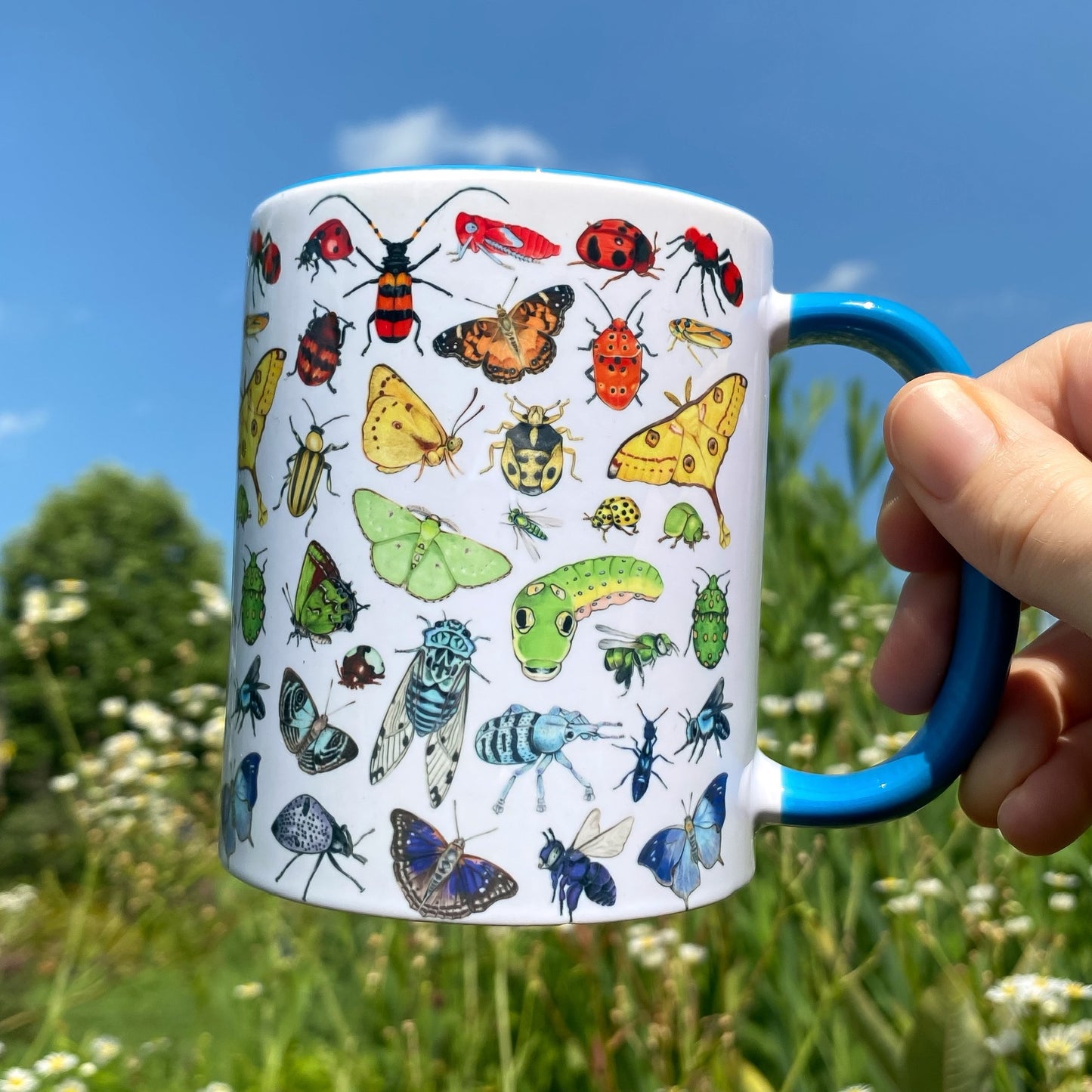 A mug featuring an illustration of rainbow insects