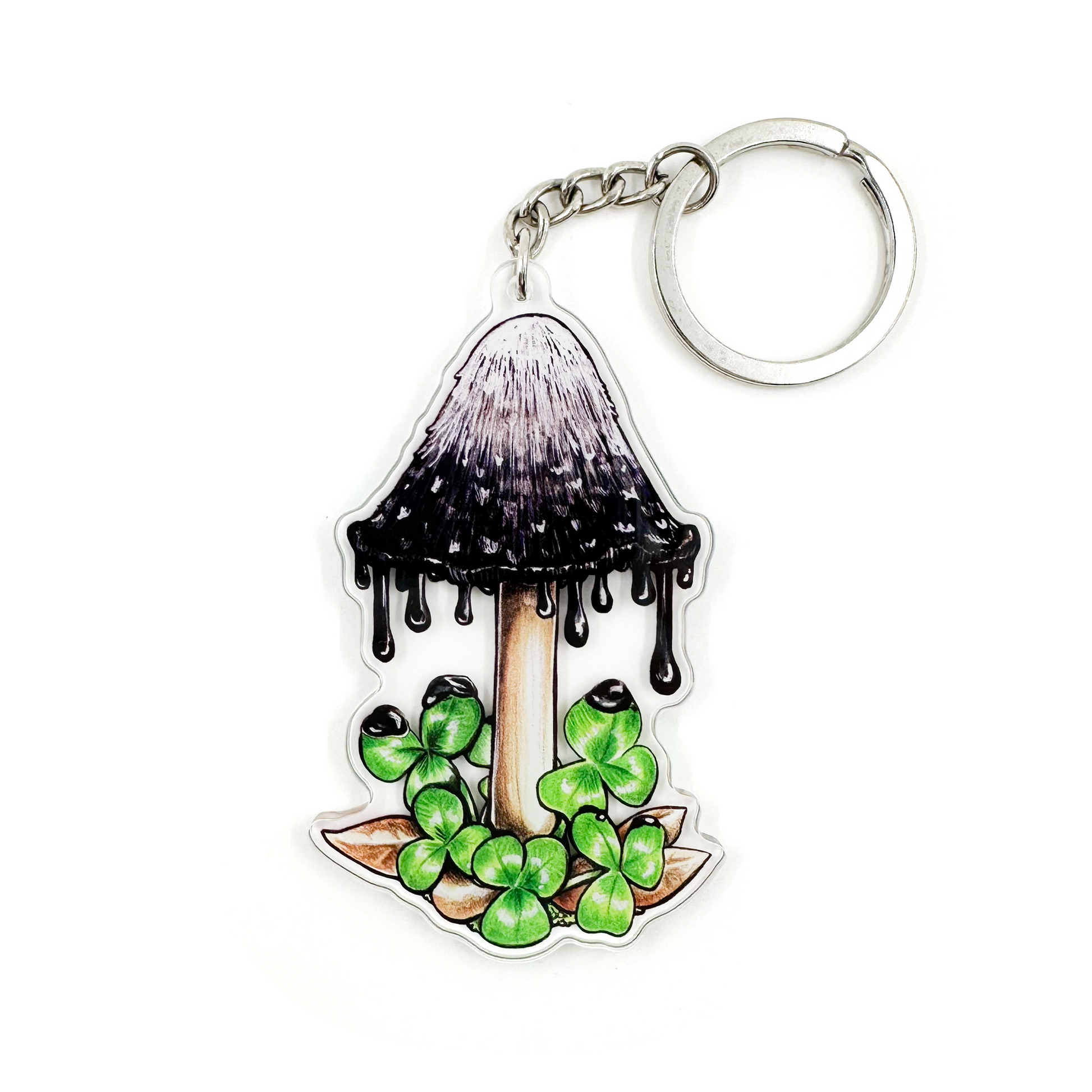 A keychain featuring an illustration of an inky cap mushroom