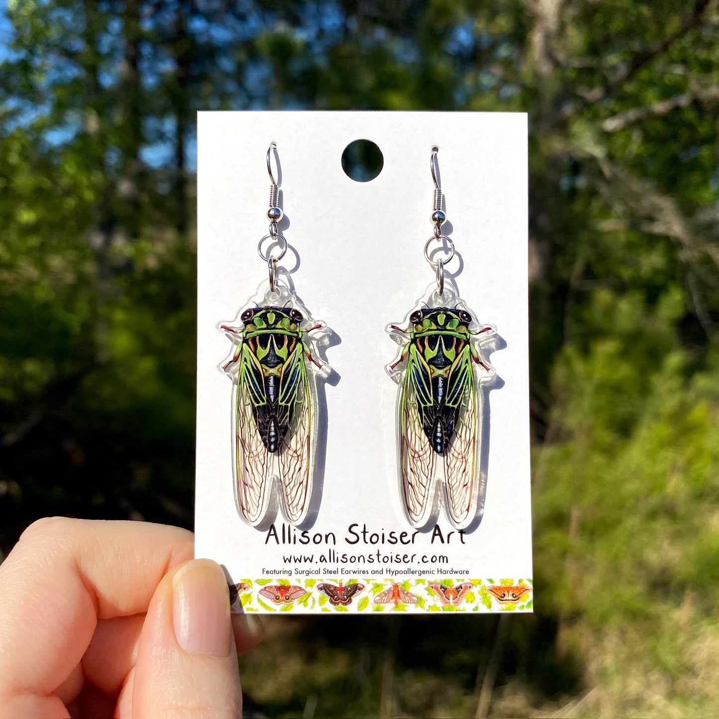 A pair of acrylic earrings of green linnes cicadas
