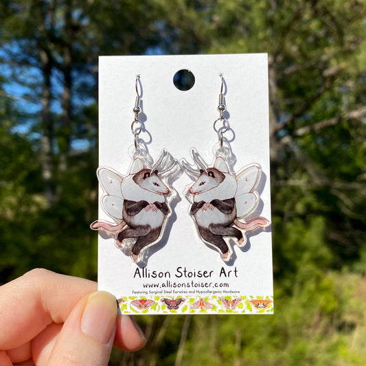 Earrings with acrylic charms of opossums with white agreeable tiger moth wings