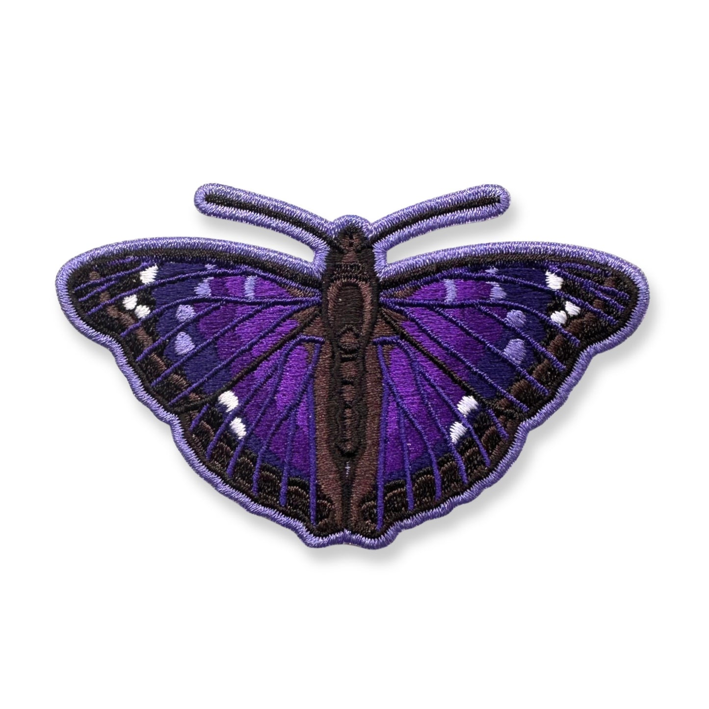 An embroidered Agathina emperor butterfly patch with purple and black wings and small white spots, shown on a plain white background.
