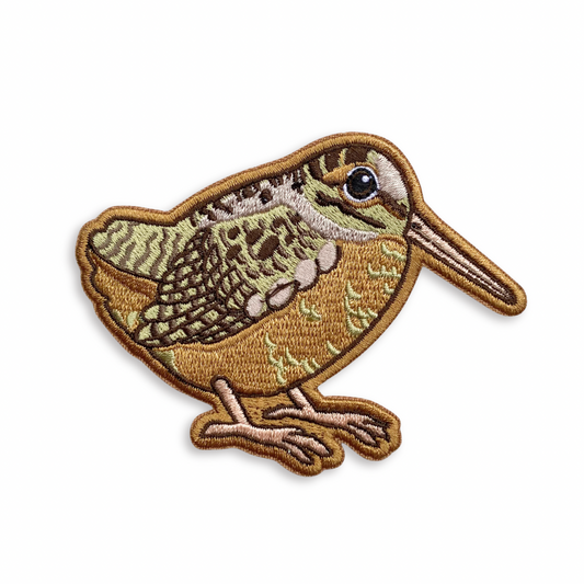 Embroidered patch of a woodcock on a white background