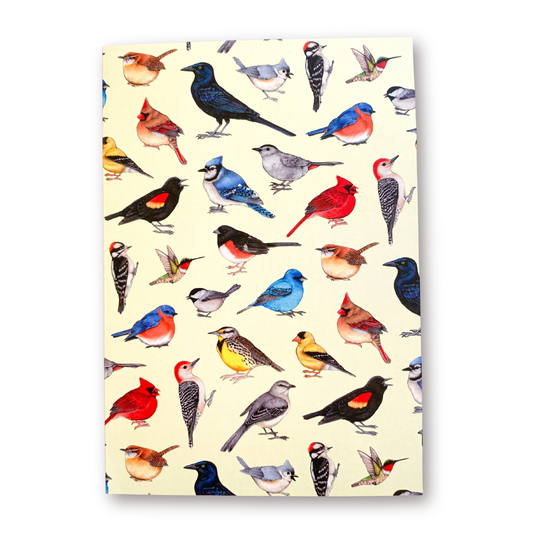 Notebook with colorful bird pattern on a beige background