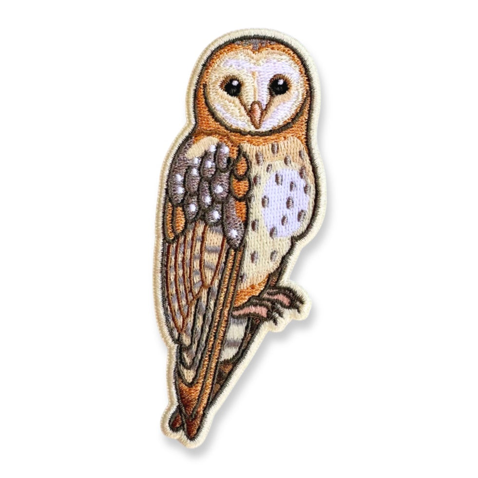 Embroidered patch of a barn owl on a white background