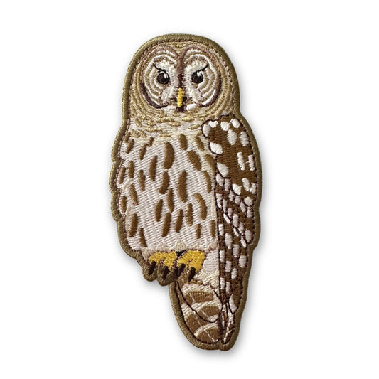 Embroidered patch of an owl on a white background